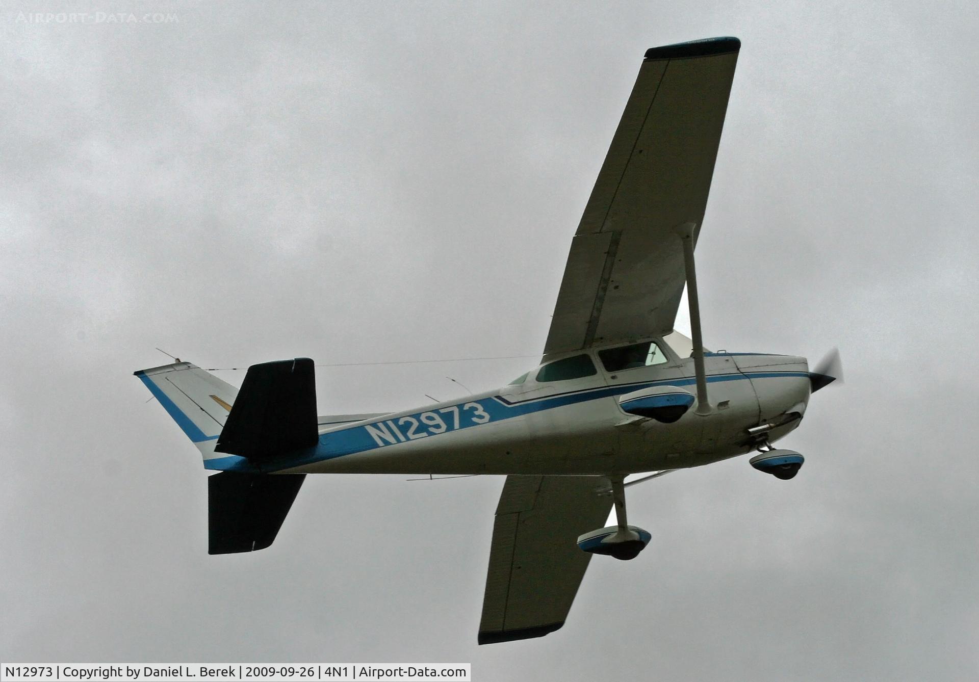 N12973, 1973 Cessna 172M C/N 17262418, A 1973 Cessna Skyhawk peels away under a brooding sky.
