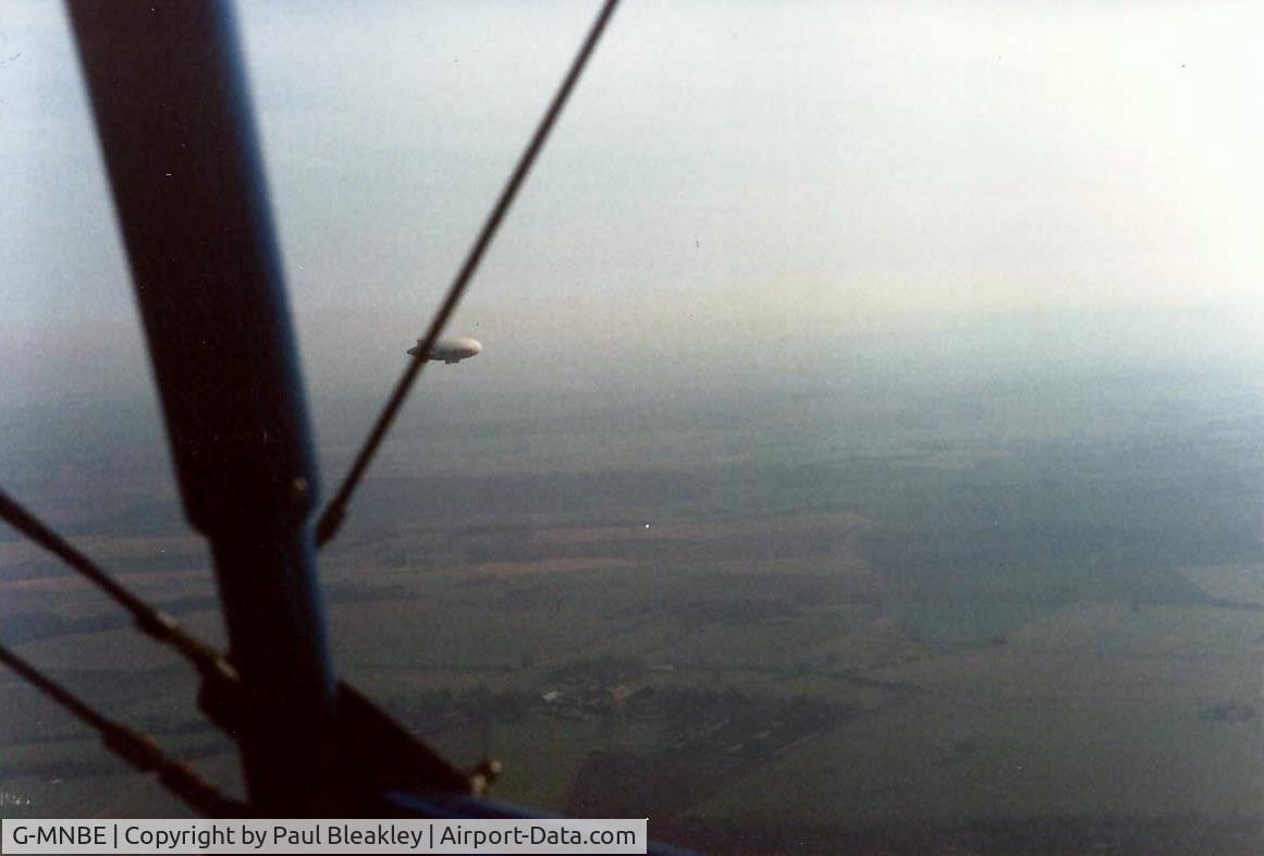 G-MNBE, 1985 Southdown International Ltd PUMA SPRINT C/N SN1121/0050, Flying alongside an aiship