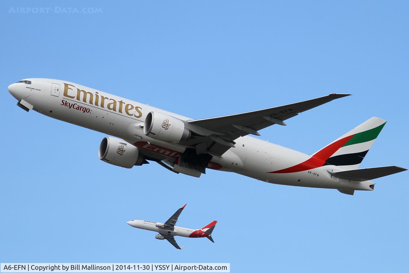 A6-EFN, 2014 Boeing 777-F1H C/N 42232, As VH-VYG banks right after take off from 34R