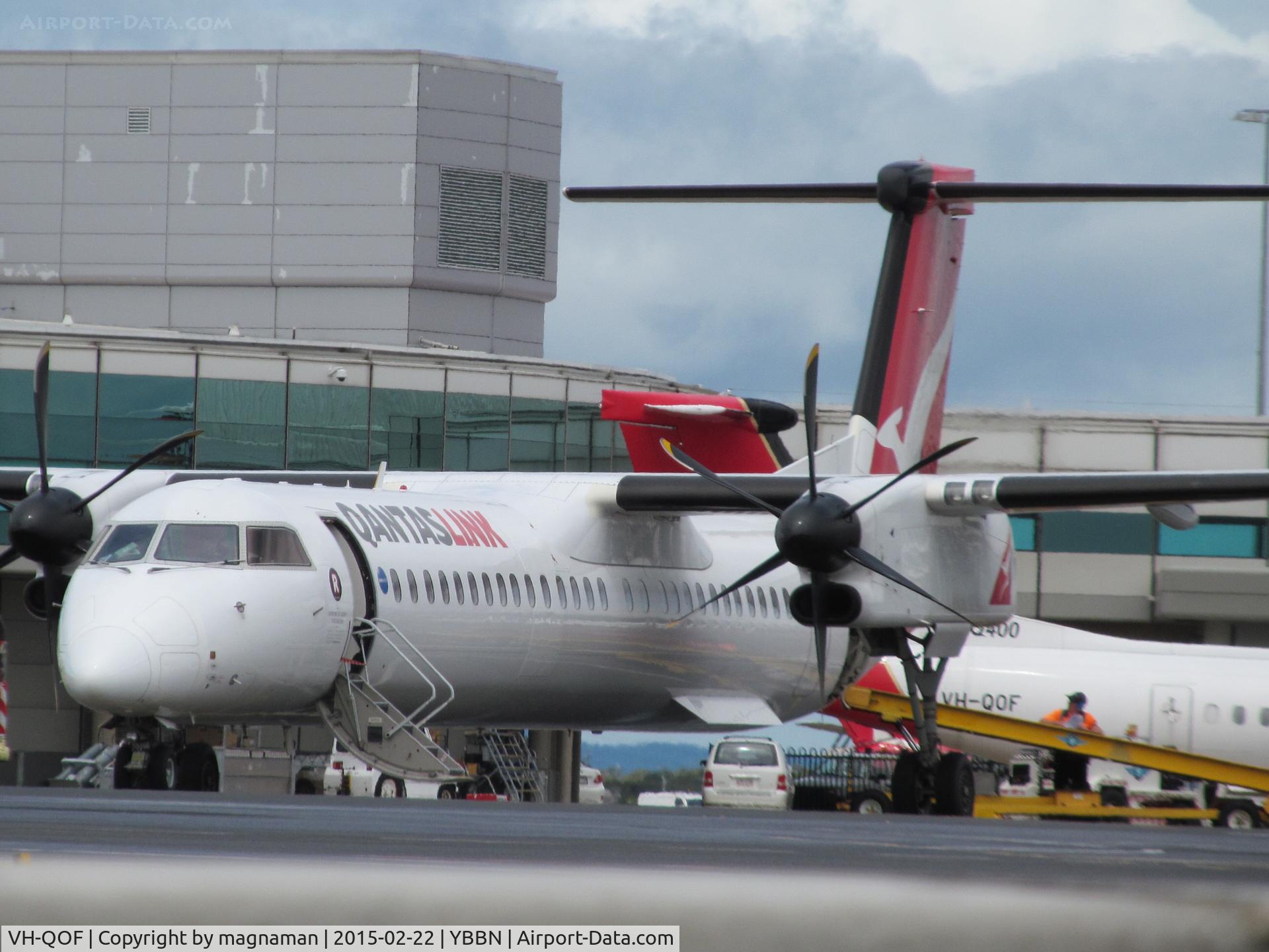 VH-QOF, 2006 De Havilland Canada DHC-8-402Q Dash 8 C/N 4128, in background behind a very annoyingly anonymous partner aircraft