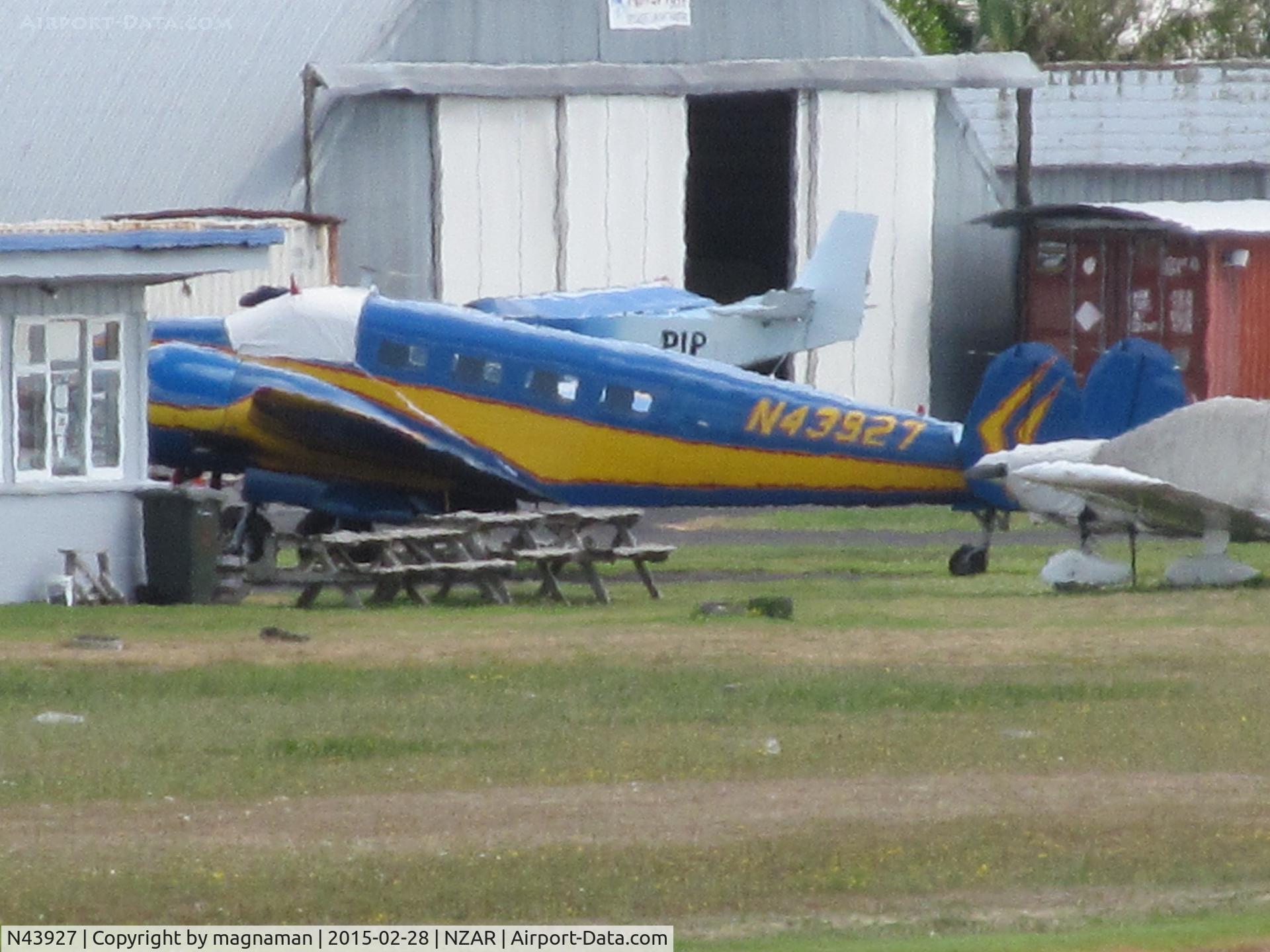 N43927, 1945 Beech D18S C/N A-26, long shot across airfield - up from south island for spot of work