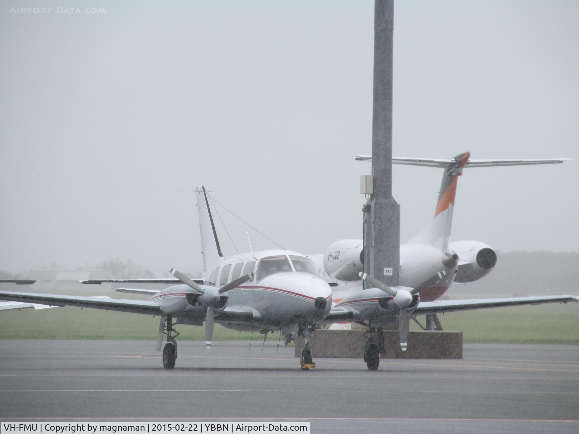 VH-FMU, 1982 Piper PA-31-310 Navajo Navajo C/N 31-8212015, with VH-JGB biz jet in background. On GA ramp.