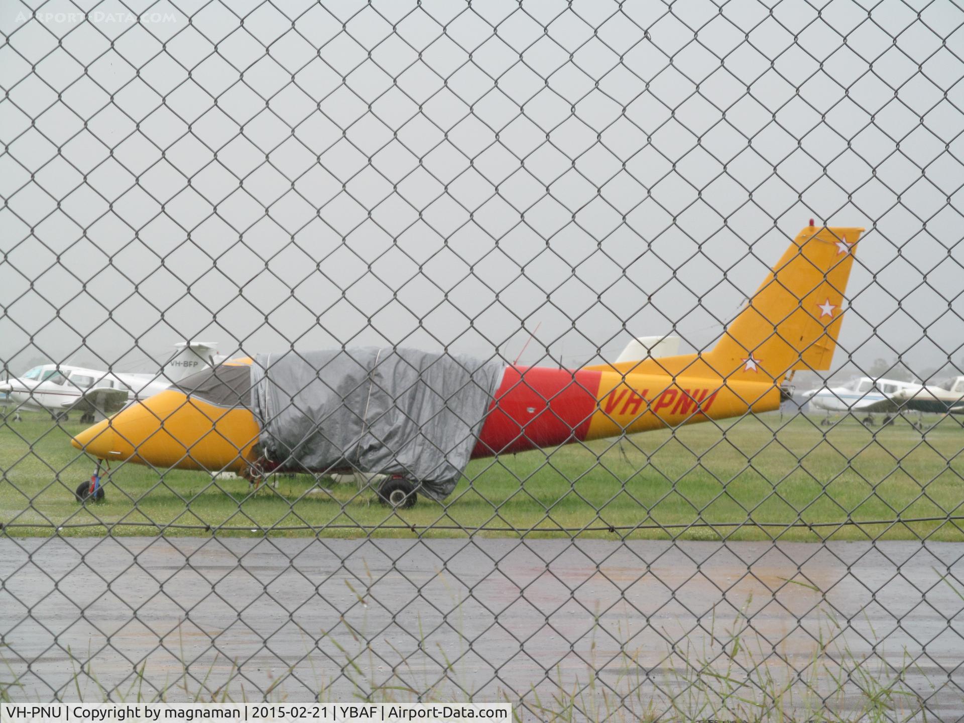 VH-PNU, 1976 Partenavia P-68B C/N 84, too wet to get out of car and poke camera through fence!!!