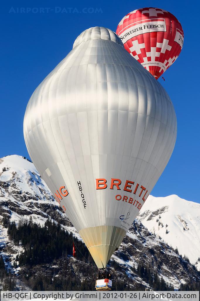 HB-QGF, 2000 Cameron Balloons Ltd RX-120 C/N 4748, Orbiter together with HB-QMS 'Swiss Meat' over famous Château-d'Oex village near Gstaad