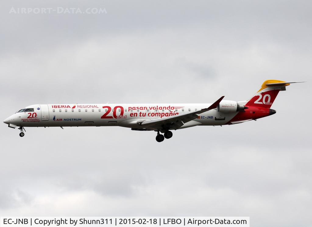 EC-JNB, 2005 Bombardier CRJ-900 (CL-600-2D24) C/N 15057, Landing rwy 32L in 20th anniversary c/s... Only on left side