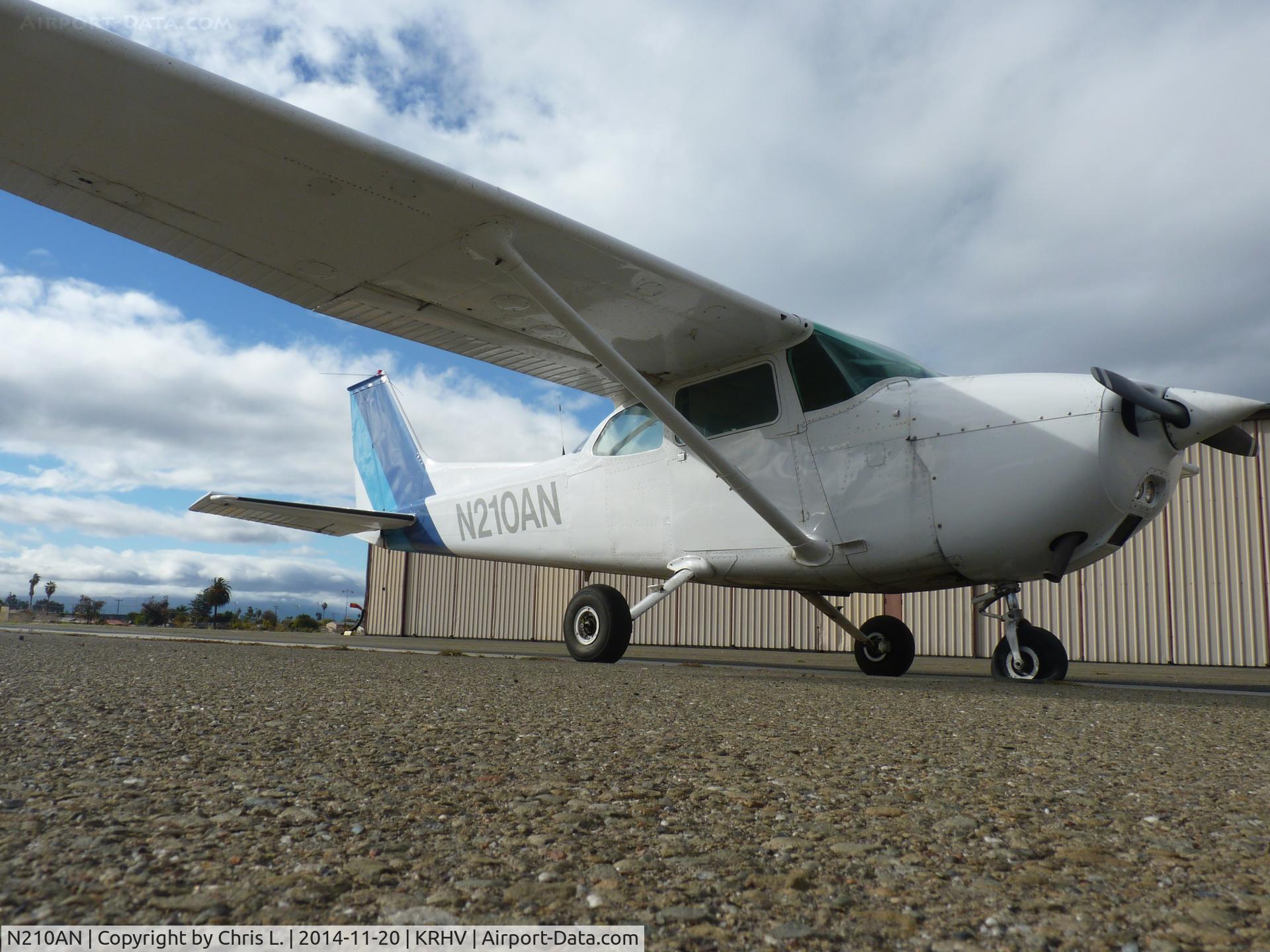 N210AN, 1975 Cessna 172M C/N 17264678, One of the flight school's Cessna 172 gets a flat tire and pulls into the south tie-downs for repairs.