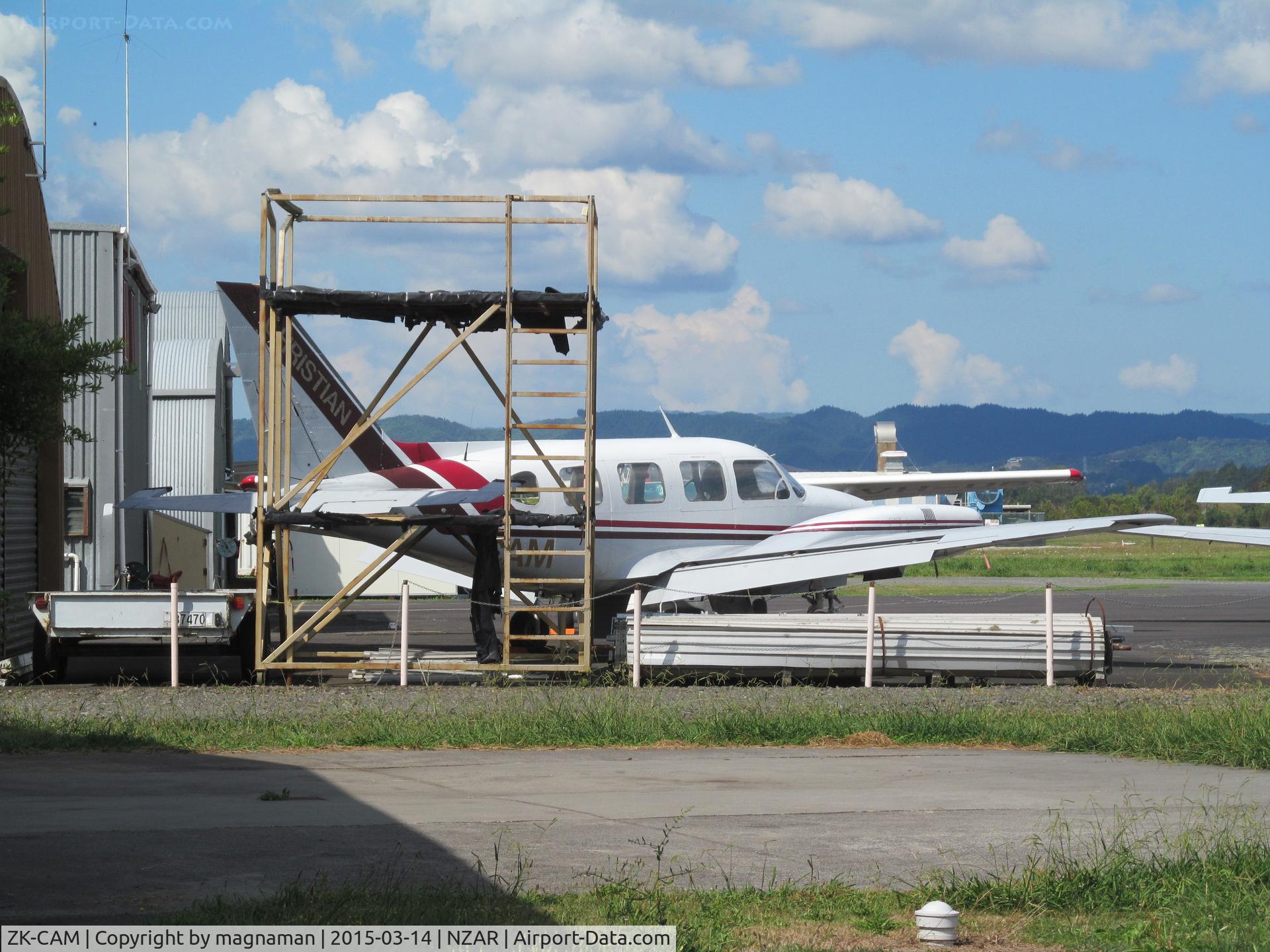 ZK-CAM, Piper PA-31-310 Navajo Navajo C/N 31-261, outside Christian Aviation hangar - new C206 VH-UBV is behind