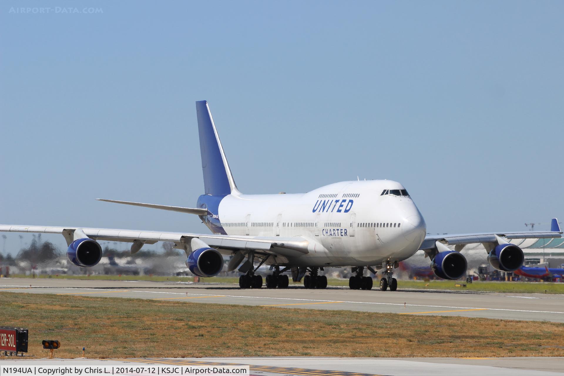 N194UA, 1997 Boeing 747-422 C/N 26892, A rare 1997 United Airlines Charter Boeing 747 at San Jose for a military charter. It's back taxiing for departure.