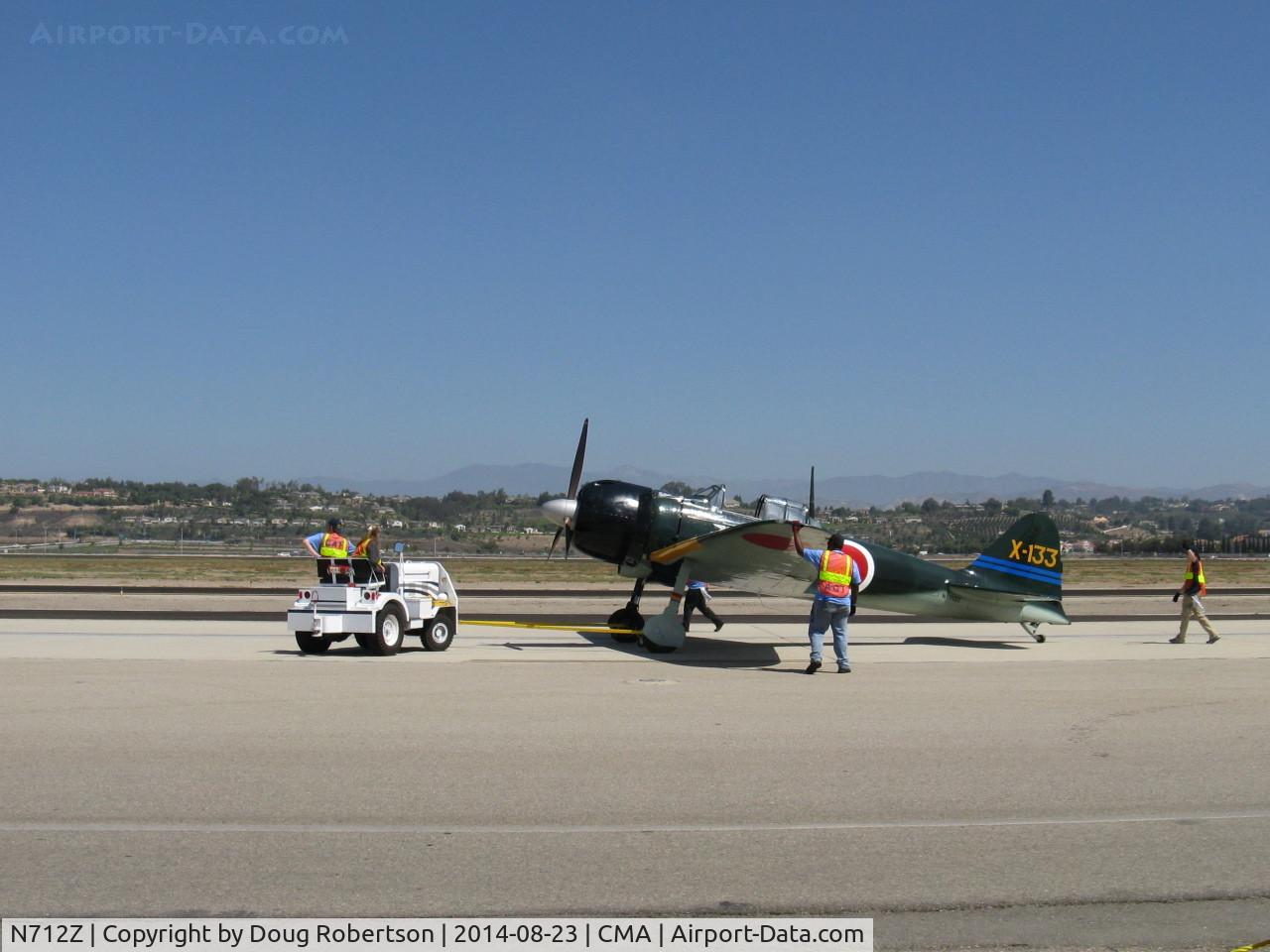 N712Z, 1942 Mitsubishi A6M3 Reisen (Zero) C/N 3869, 1942 Mitsubishi A6M3 ZERO-SEN, P&W R-1830 1,130 Hp upgrade from original Sakai. Spotting the aircraft on air show flight line ramp.