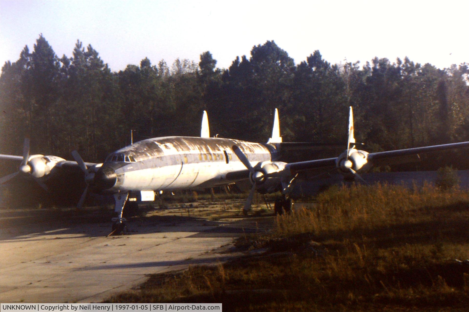 UNKNOWN, Miscellaneous Various C/N unknown, Derelict Lockheed Constellation (unidentified) possibly used for training ground staff - parked at northern end on main runway SFB - as seen from departing flight.  Scanned from original slide