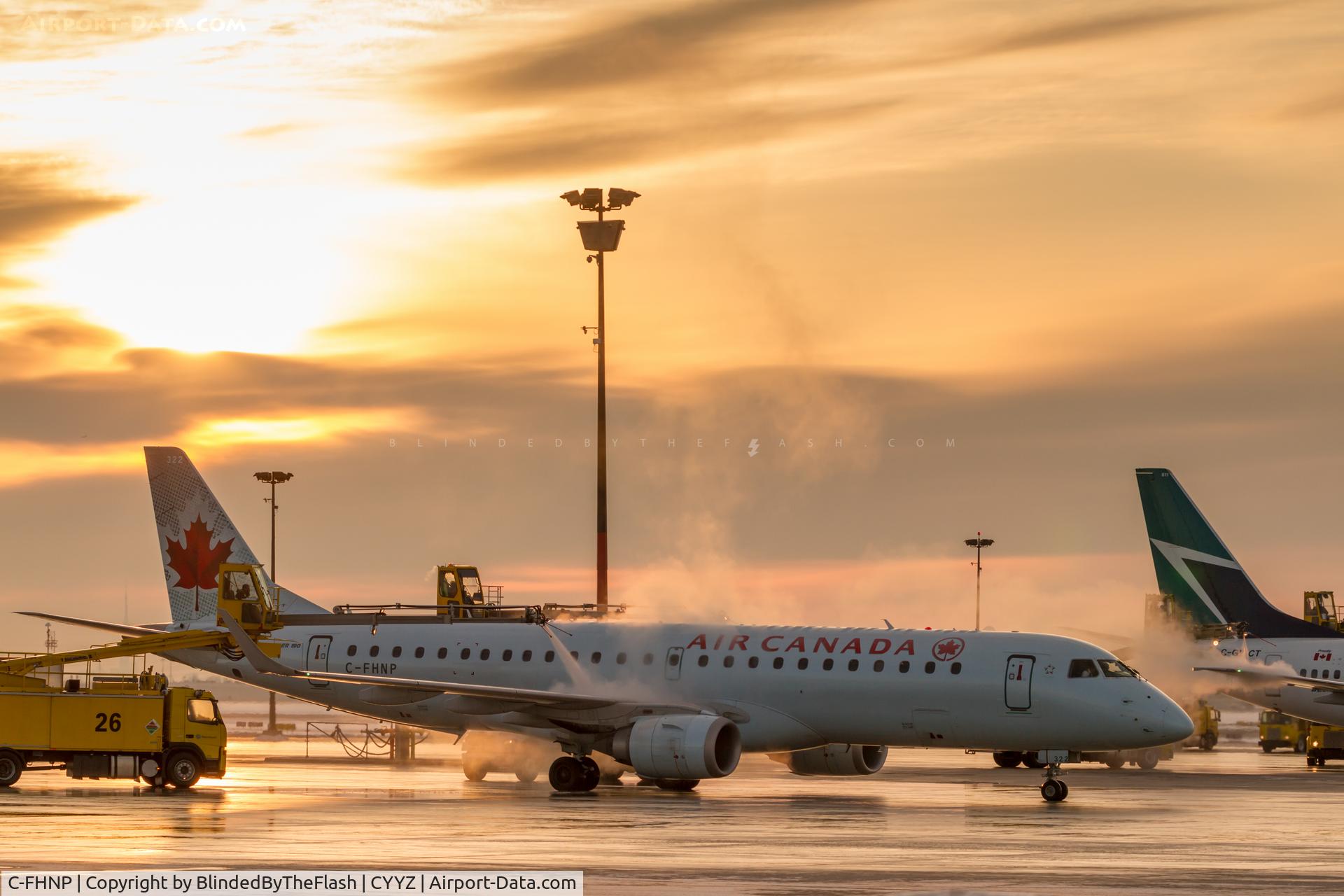 C-FHNP, 2007 Embraer 190AR (ERJ-190-100IGW) C/N 19000071, Deicing in Toronto at sunrise