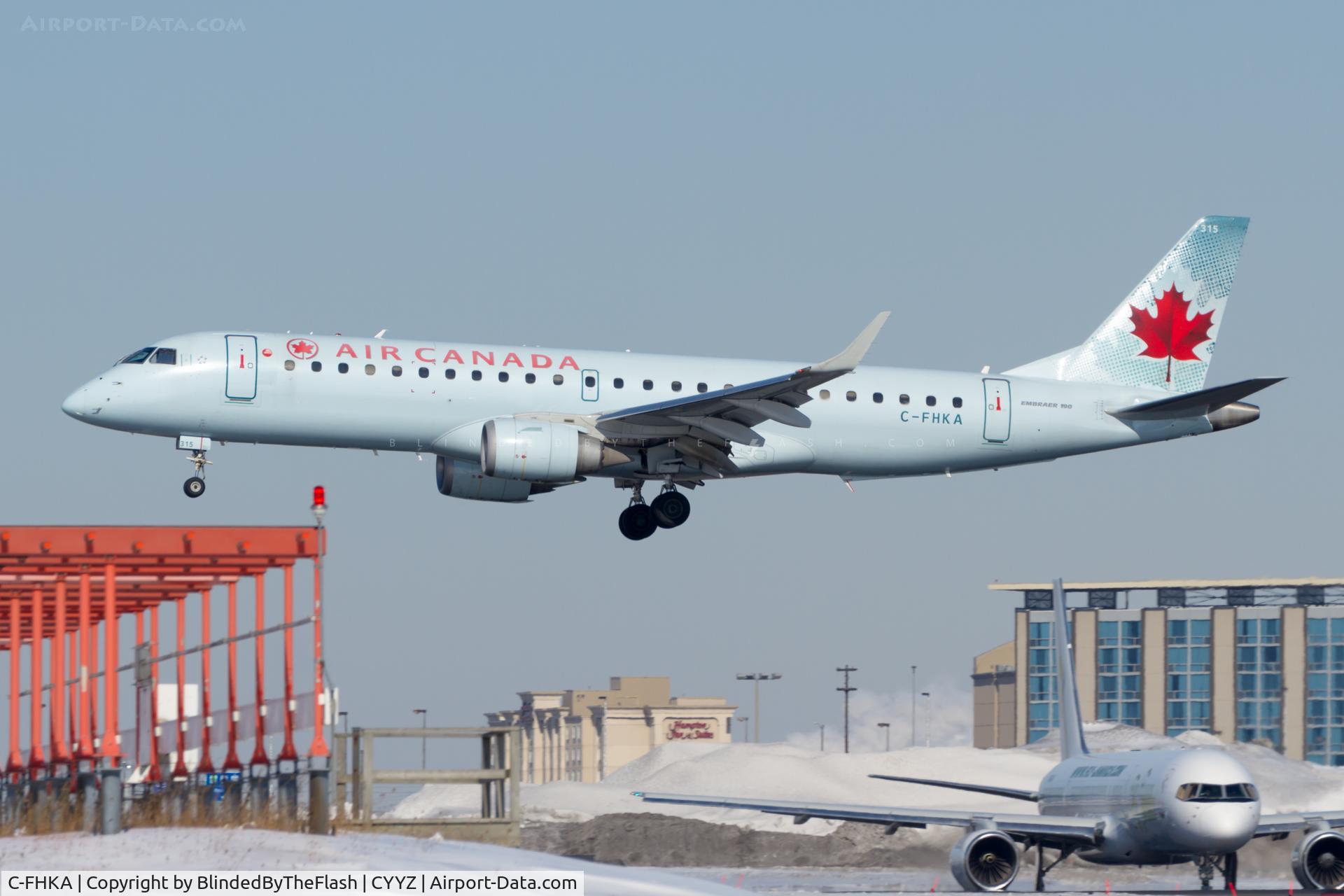 C-FHKA, 2006 Embraer 190AR (ERJ-190-100IGW) C/N 19000046, Moments from touchdown on 24R at Toronto Pearson while a Fly Jamaica 757 looks on