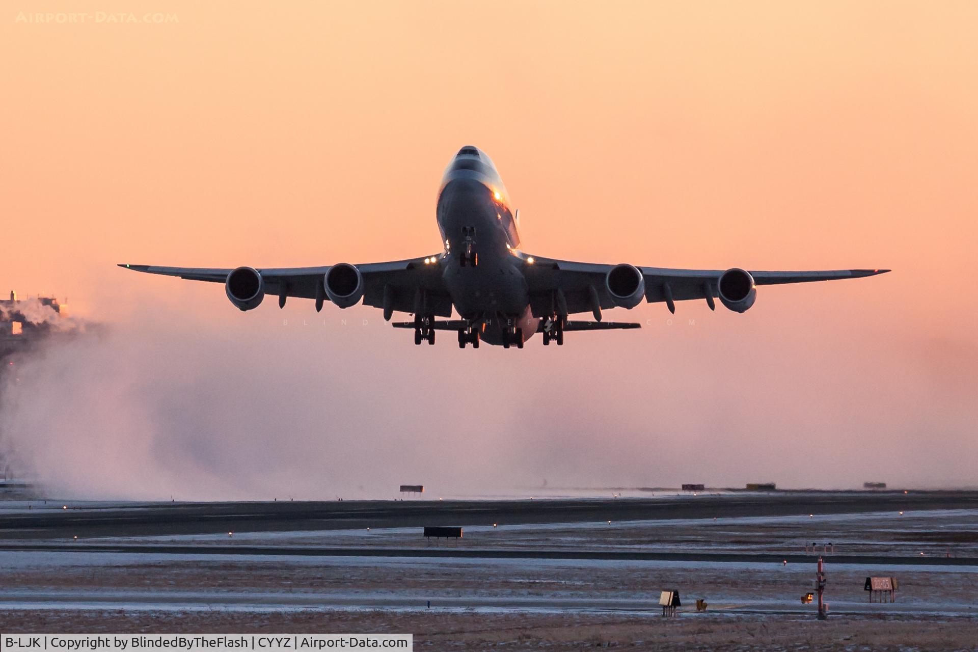 B-LJK, 2013 Boeing 747-867F/SCD C/N 43394, Departing runway 05 at Toronto Pearson at sunset, blowing clouds of snow behind it