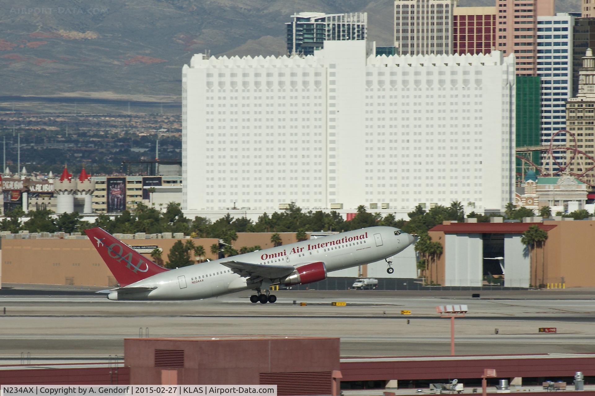 N234AX, 2001 Boeing 767-224 C/N 30436, Omni Air International, is here departing in front of the Tropicana Hotel at Las Vegas Int'l(KLAS)