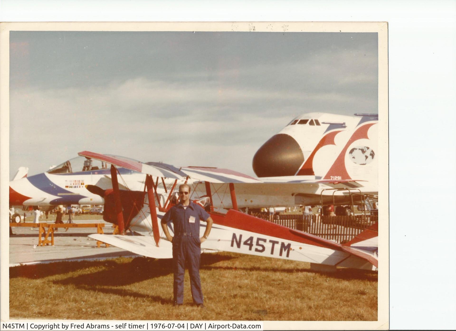 N45TM, 1945 De Havilland DH-82A Tiger Moth II C/N 86621, Taken at the Bicentennial Airshow in Dayton Ohio, 1976. Owner Fred Abrams posing with F-15 and C-5 in the background. Fred was the purchaser in England who put airplane in US registry. Built in 1945.