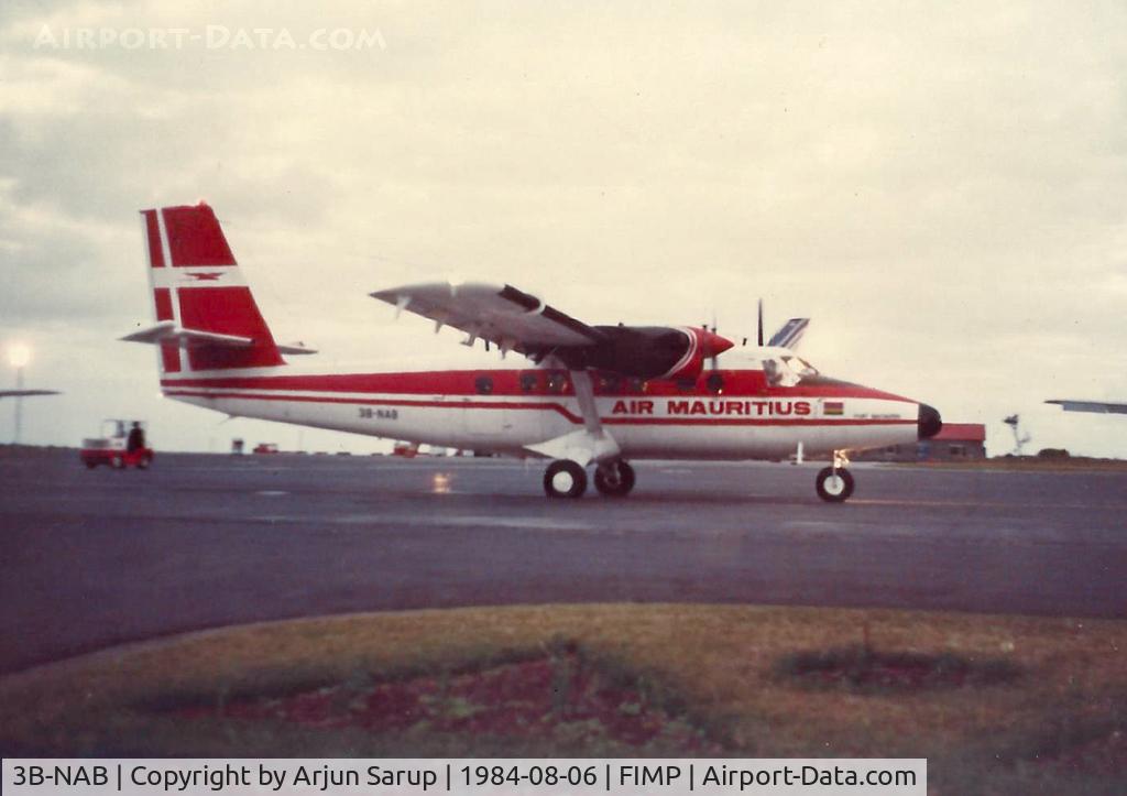 3B-NAB, 1975 De Havilland Canada DHC-6-300 Twin Otter C/N 442, 'Port Mathurin' taxiing past the terminal on a winter evening in August 1984. Scanned from a print.