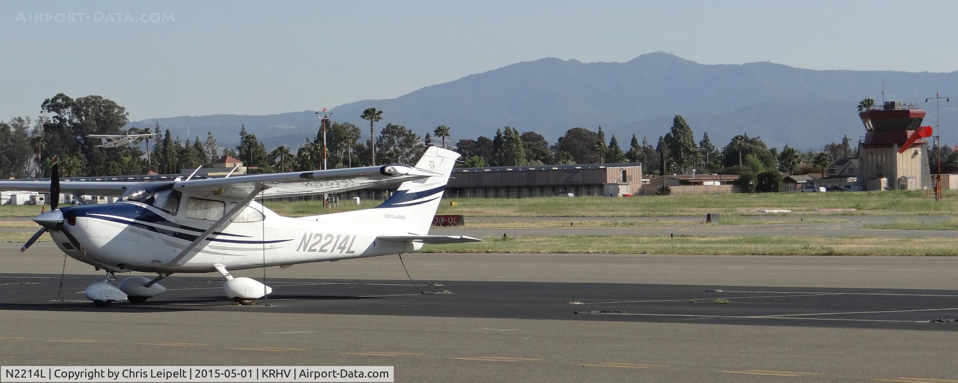 N2214L, 2005 Cessna 182T Skylane C/N 18281718, A local 2005 Cessna 182T sitting on the transient ramp after dropping off some passengers. Cessna N54102 and the Reid Hillview Tower both in the background.