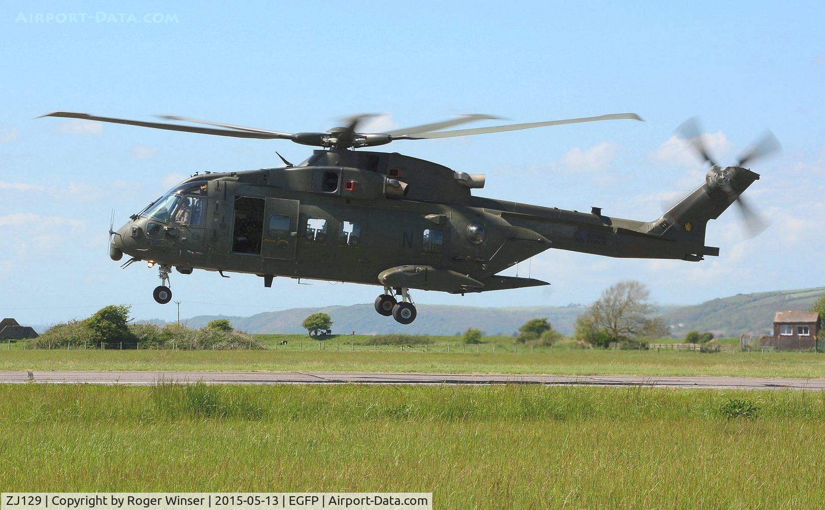 ZJ129, Westland Merlin HC.4 C/N 50167/RAF13, Visiting RN Merlin helicopter coded N of 846 NAS departing the airport after taking on fuel. The helicopter still carries the badge of the disbanded 78 Squadron RAF on the port side of the boom.