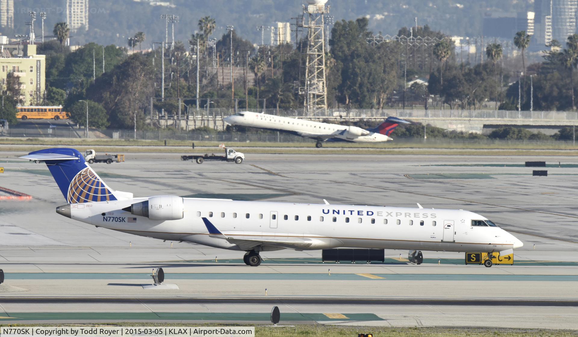 N770SK, 2006 Canadair CL-600-2C10 Regional Jet CRJ-700 C/N 10243, Taxiing to gate at LAX