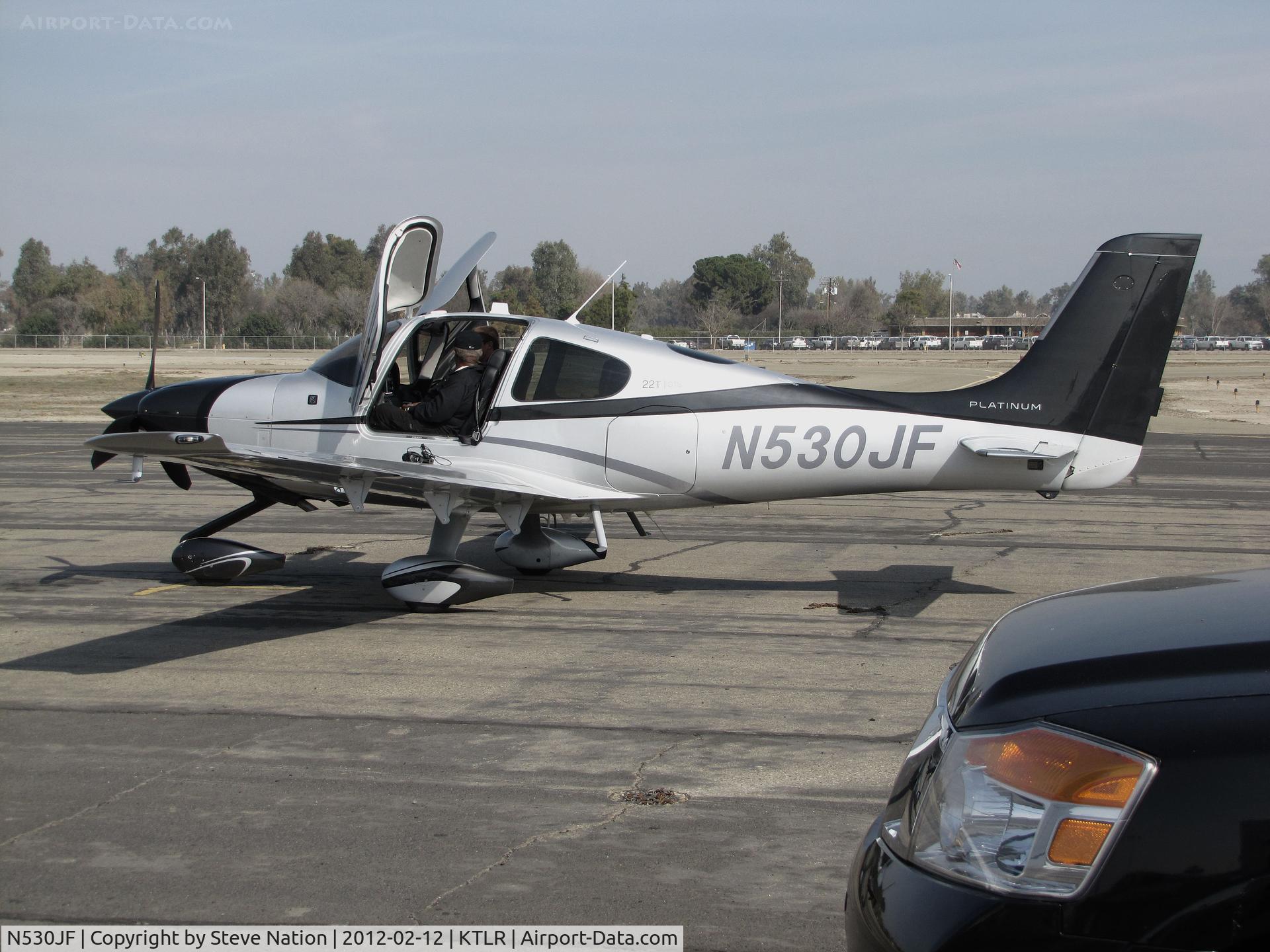 N530JF, 2014 Cirrus SR22T C/N 0690, Brand new Cirrus Design SR22T demonstrator with pilot side door open @ Mefford Field (Tulare, CA) for 2014 International Ag Expo