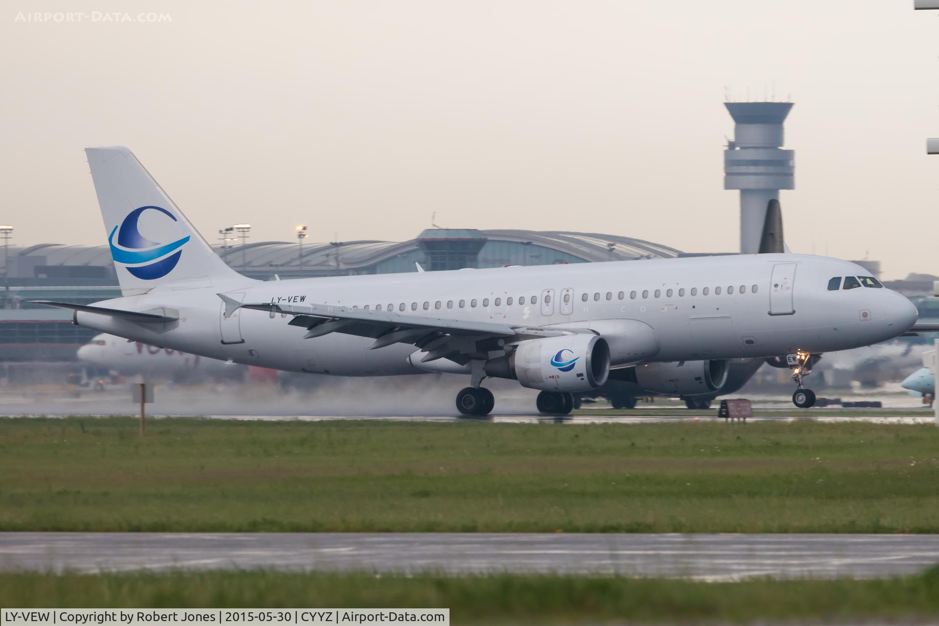 LY-VEW, 1999 Airbus A320-214 C/N 1005, Landing in the rain on 23 at Toronto Pearson.