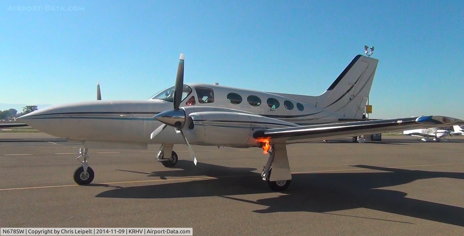 N678SW, Cessna 421C Golden Eagle C/N 421C1023, A transient Cessna 421C (Monterey, CA) starting up at the inside ramp after dropping off passengers at Reid Hillview Airport, CA. The flame from the exhaust was pretty cool.