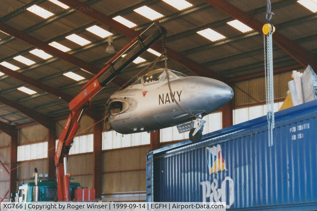 XG766, 1954 De Havilland DH-115 Sea Vampire T.22 C/N 15641, The forward fuselage of an ex-RN, ex-RAN aircraft being lifted out of the container in DHA's hangar. The aircraft was coded 874/NW in RAN service when operated by 724 Squadron at Nowra, Australia. On 19/05/2000 the airframe was registered G-SPDR.