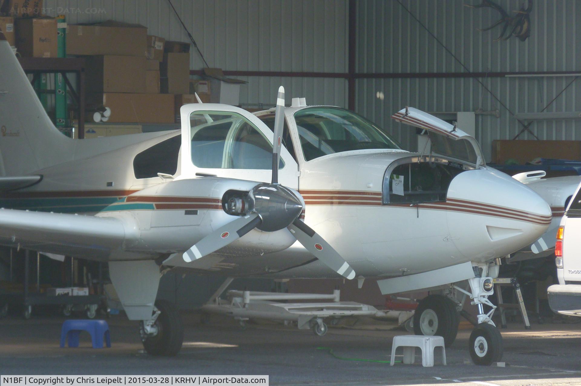 N1BF, 1973 Beech E-55 Baron C/N TE-961, A local 1973 Baron E55 parked in its hangar with the baggage doors open after an IFR flight at Reid Hillview Airport, CA.