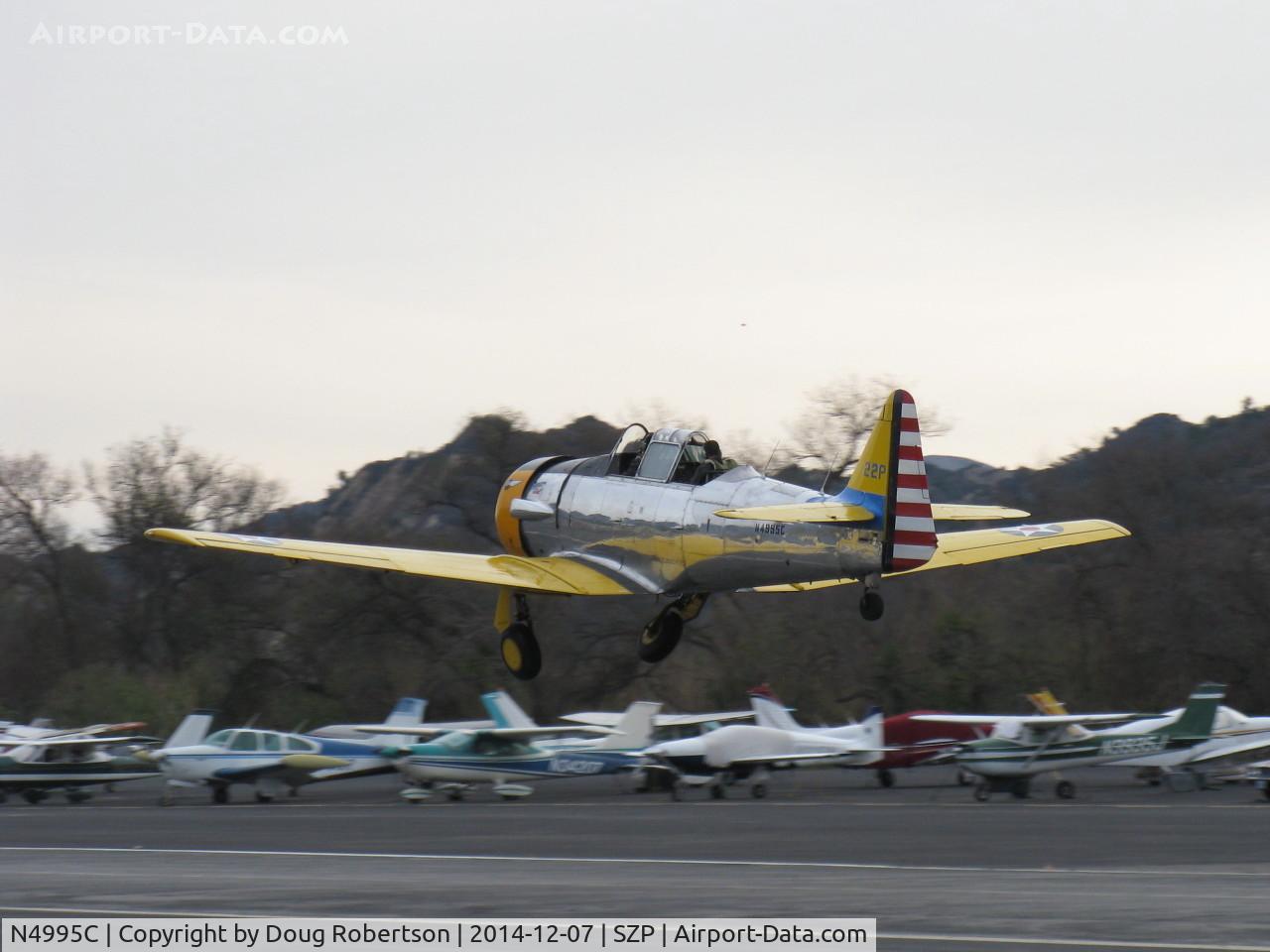 N4995C, 1949 North American T-6G Texan C/N 168-481, 1949 North American T-6G TEXAN 'Thirsty Girl', 1949 factory reman, P&W R-1340 600 Hp, takeoff climb Rwy 04, gear in transit, will do commemoration flour bombing of river target on anniversary of 7 Dec. 1941 Pearl Harbor attack.