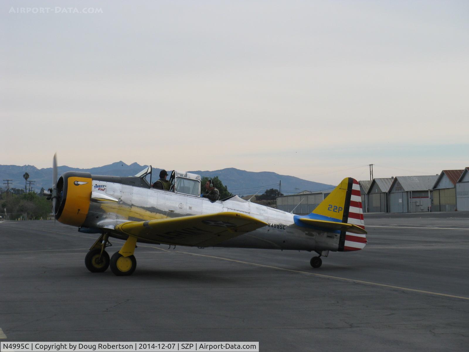N4995C, 1949 North American T-6G Texan C/N 168-481, 1949 North American T-6G TEXAN 'Thirsty Girl' of Condor Squadron, 1949 factory reman, P&W R-1340 600 Hp radial, taxi near fuel dock, loaded with flour bombs and bombardier in rear cockpit.