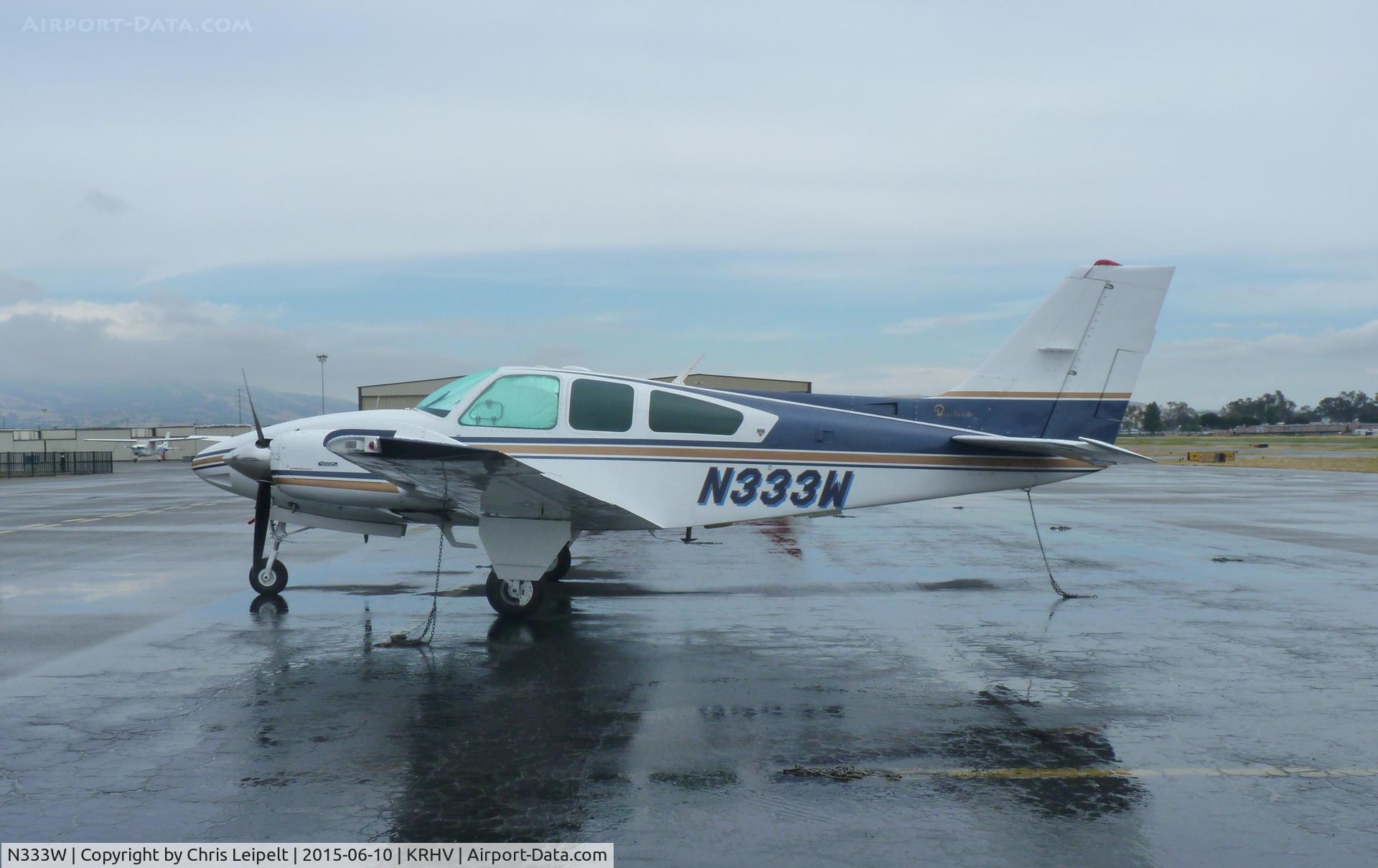 N333W, 1979 Beech E-55 Baron C/N TE-1172, A transient 1979 Beechcraft Baron E-55 (GRECMAR AIR INC - WILMINGTON, DE) sitting at the transient ramp in between rainstorms at Reid Hillview Airport, CA.