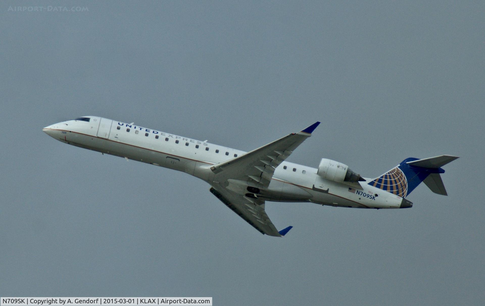 N709SK, 2004 Bombardier CRJ-701ER (CL-600-2C10) Regional Jet C/N 10159, SkyWest (United Express cs.), is here departing at Los Angeles Int'l(KLAX)