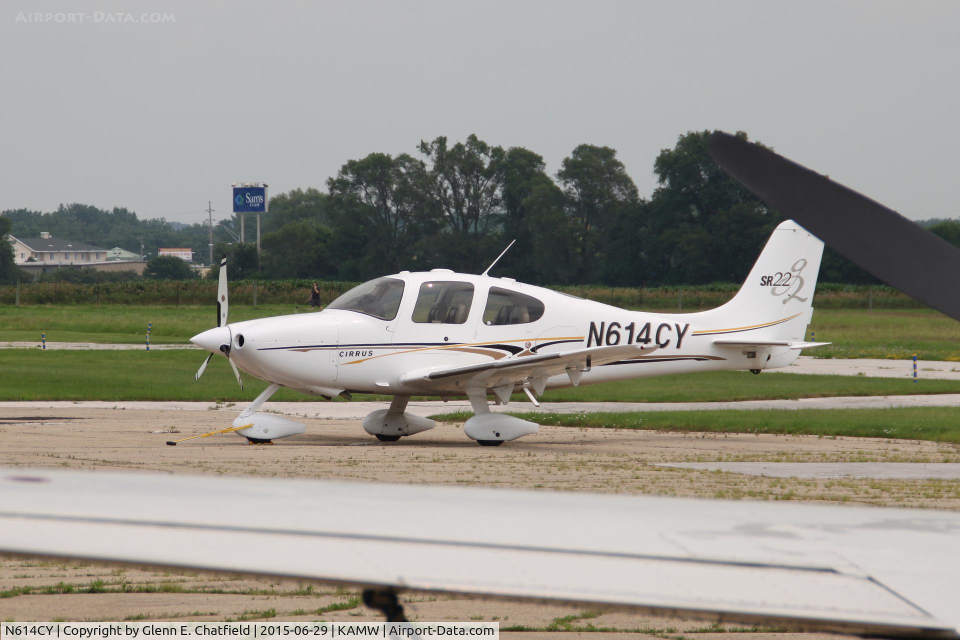 N614CY, 2004 Cirrus SR22 G2 C/N 1050, Photographed by hanging over a fence and shooting over the wing of a twin Cessna.