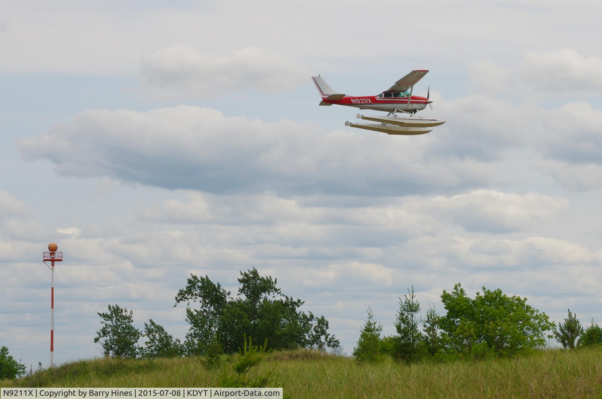 N9211X, 1961 Cessna 182E Skylane C/N 18253611, Approaching the water at Duluth's Sky Harbor Airport