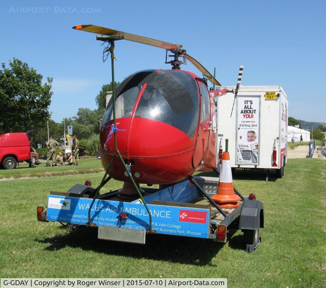 G-GDAY, 1987 Robinson R22 Beta C/N 0676, Off airport. Grounded R-22 Beta helicopter used to raise funds for the Wales Air Ambulance charity in position by the Swansea foreshore ready for the Wales National Airshow 2015.