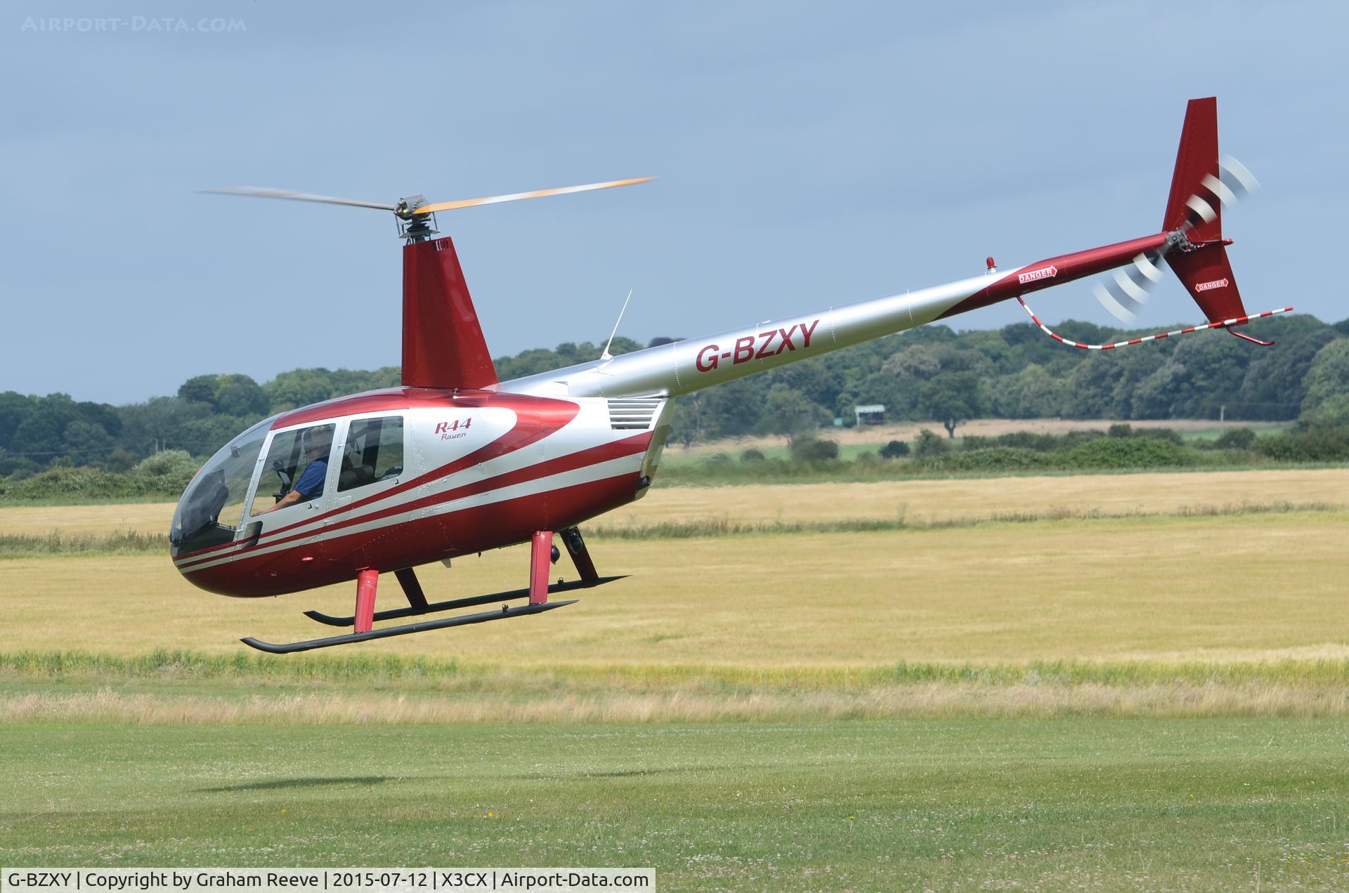 G-BZXY, 2001 Robinson R44 Raven C/N 1027, Departing from Northrepps.