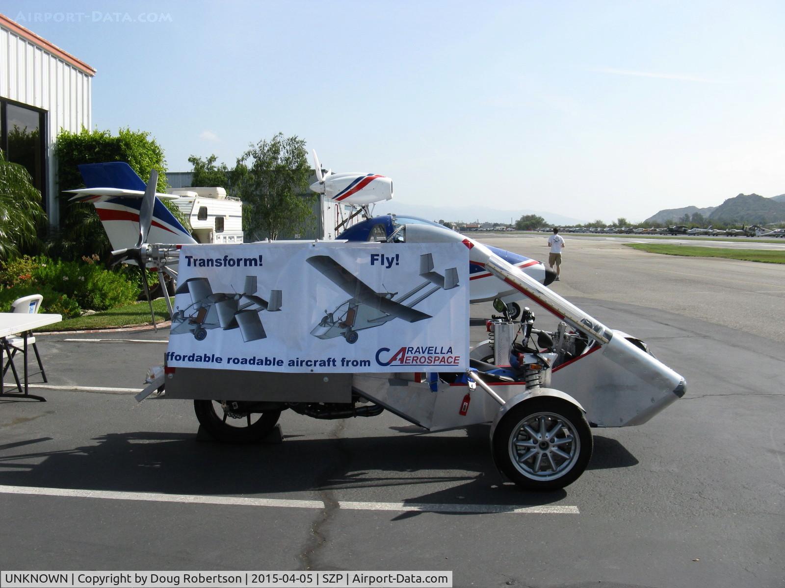 UNKNOWN, Miscellaneous Various C/N unknown, Caravella Aerospace CaraVellair prototype roadable aircraft, side view with advertising banner, less folding wings and twin tail boom assembly. Will have airframe/aircraft parachute incorporated.