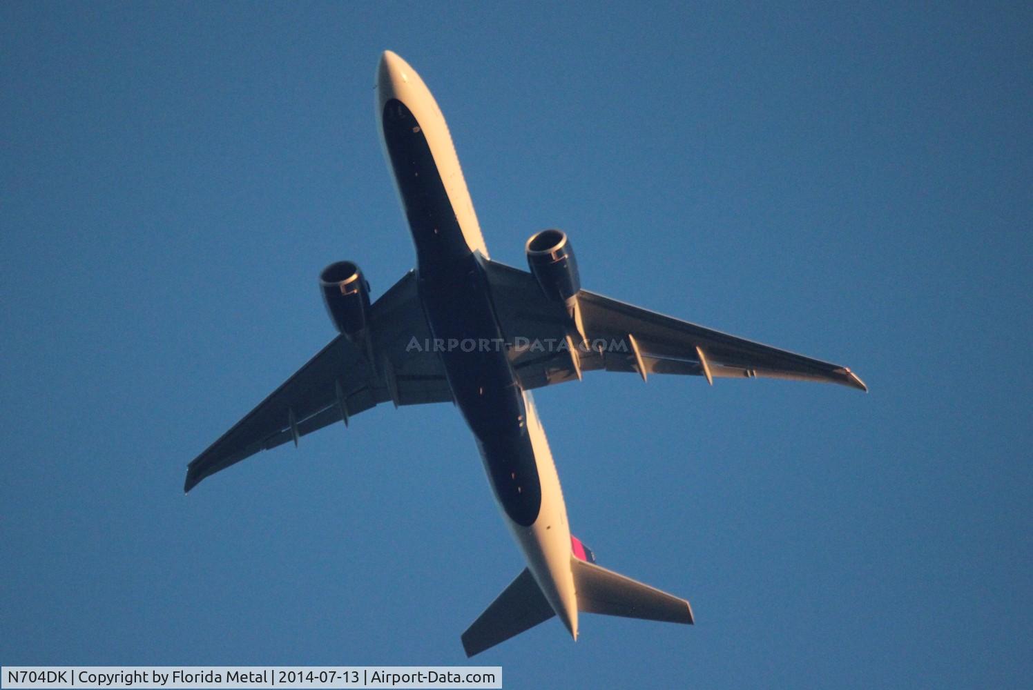 N704DK, 2009 Boeing 777-232/LR C/N 29739, Delta 777-200LR flying about 7,000 ft over my mom's house in Livonia MI on downwind about to turn base to final to DTW.  Aircraft is flying in from ATL