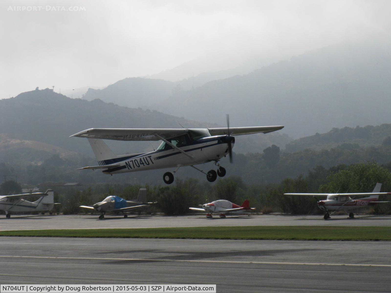 N704UT, 1976 Cessna 150M C/N 15078891, 1976 Cessna 150M, Continental O-200 100 Hp, takeoff climb Rwy 22 on a murky day