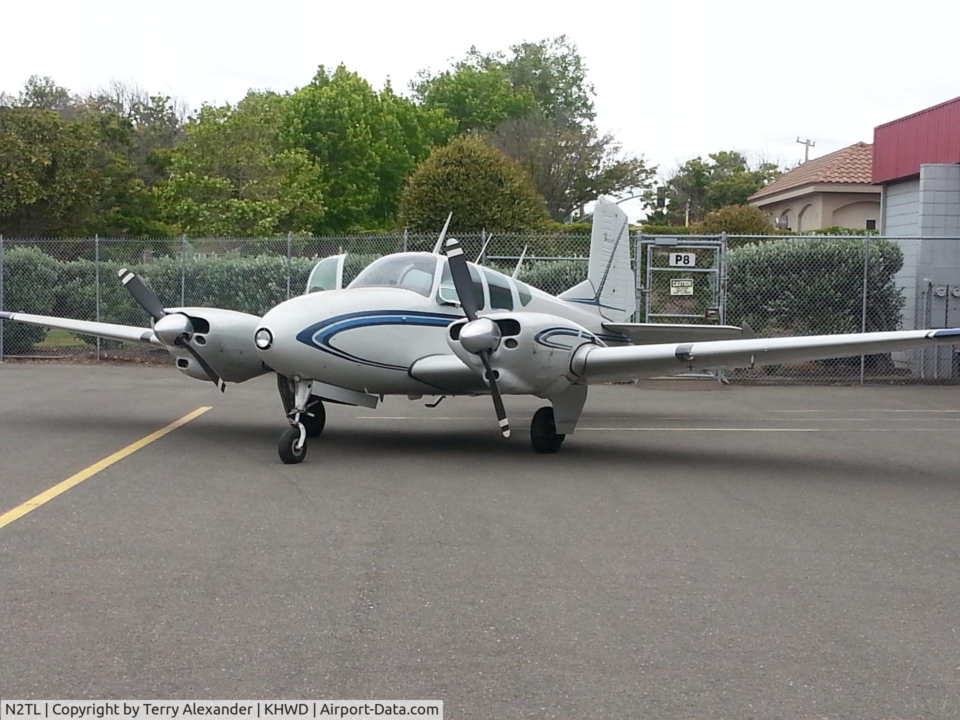 N2TL, 1959 Beech 95 C/N TD-233, Showcasing Beech Travel Air outside hangar.
