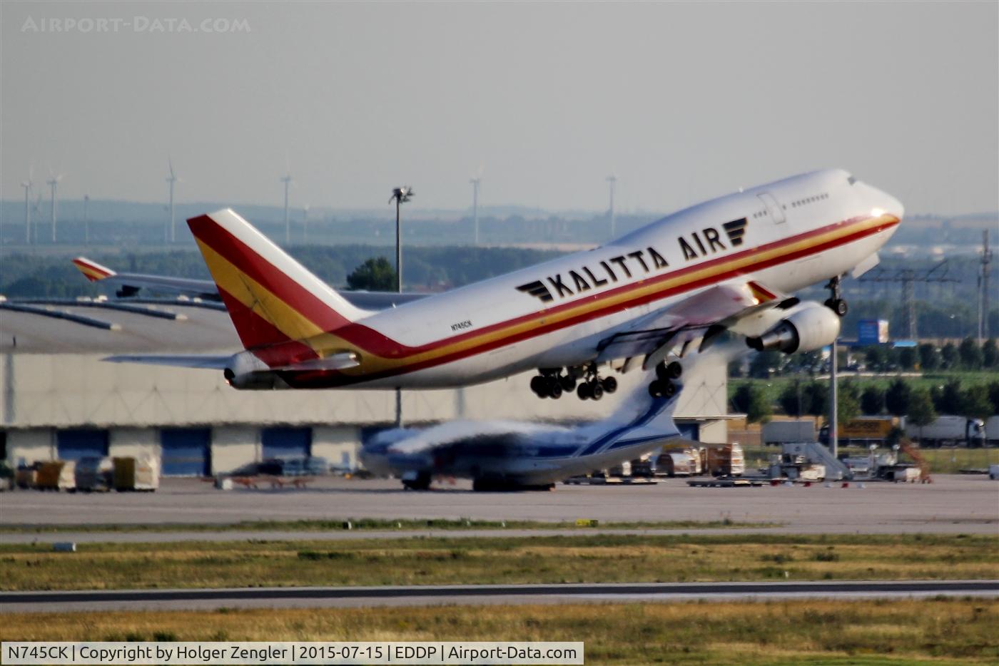 N745CK, 1998 Boeing 747-446BCF C/N 26361, Daily shuttle to CIN is leaving LEJ via rwy 26L along apron 2, passing a resting IL 97....