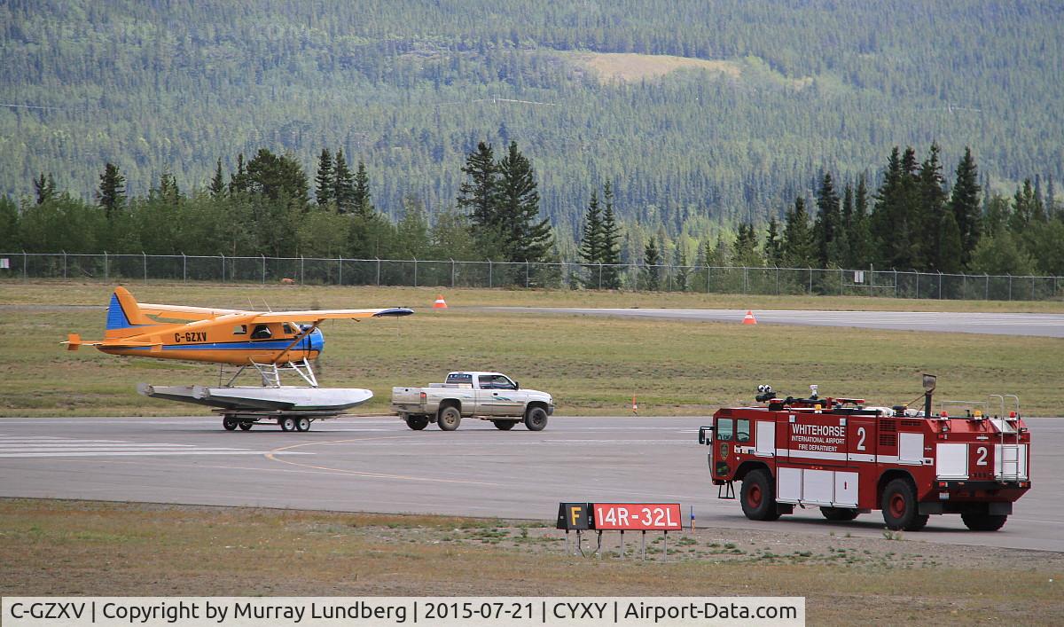 C-GZXV, 1957 De Havilland Canada U-6A Beaver C/N 1079, On floats, being launched from a trailer on a paved runway at Whitehorse, Yukon.
