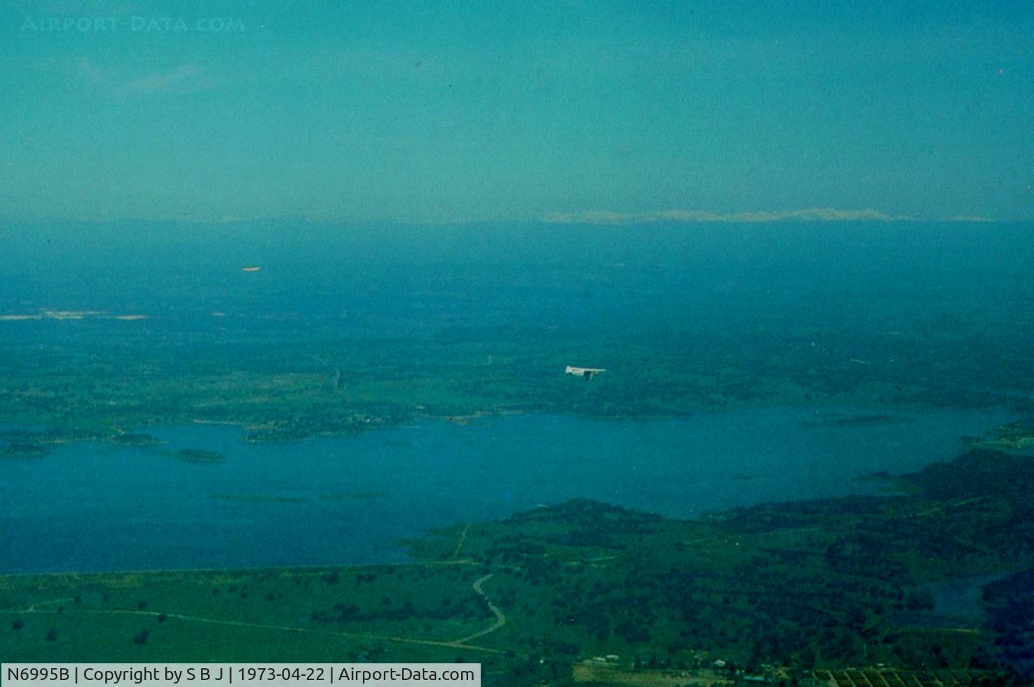 N6995B, 1956 Piper PA-18A-150 Super Cub C/N 18-5123,  Cub 95B and Bob seen flying east over a very green Calif and a full Lake Camanche as we fly to Calaveras Co airport on this beautiful Easter Sunday. I was flying Tcraft N39246.This of course was a very long time ago and befor global warming took over!