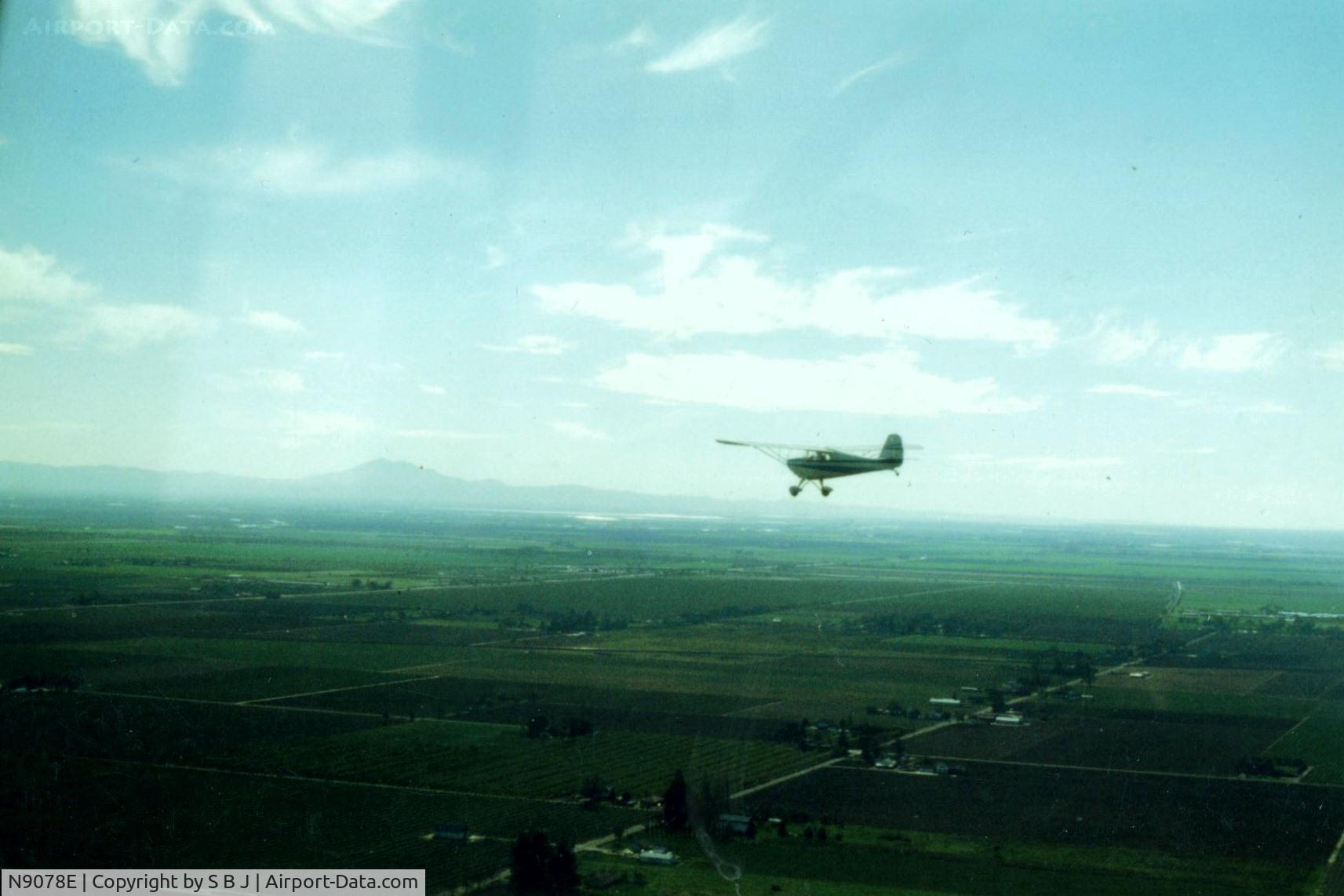 N9078E, 1946 Aeronca 11AC Chief C/N 11AC-710, 78E flys south in the Calif central valley.In the distance to the west is seen Mt Diablo (3865 ft)which is the most prominent landmark and can be seen for a hundred miles.On VFR days it made navigation easy.