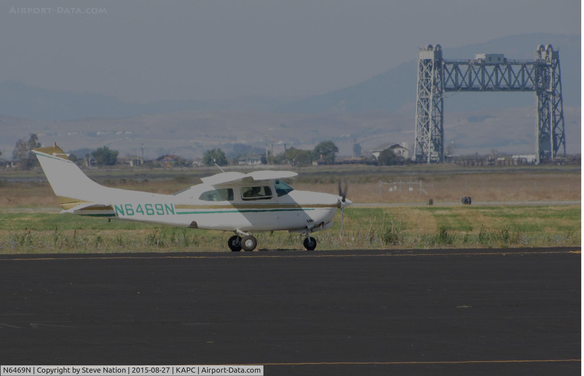N6469N, 1978 Cessna T210N Turbo Centurion C/N 21063043, Ukiah Broadcasting Corp. (Stockton, CA) 1978 Cessna T210N taxiing @ Napa County Regional Airport, CA with iconic Napa River RR Bridge in background