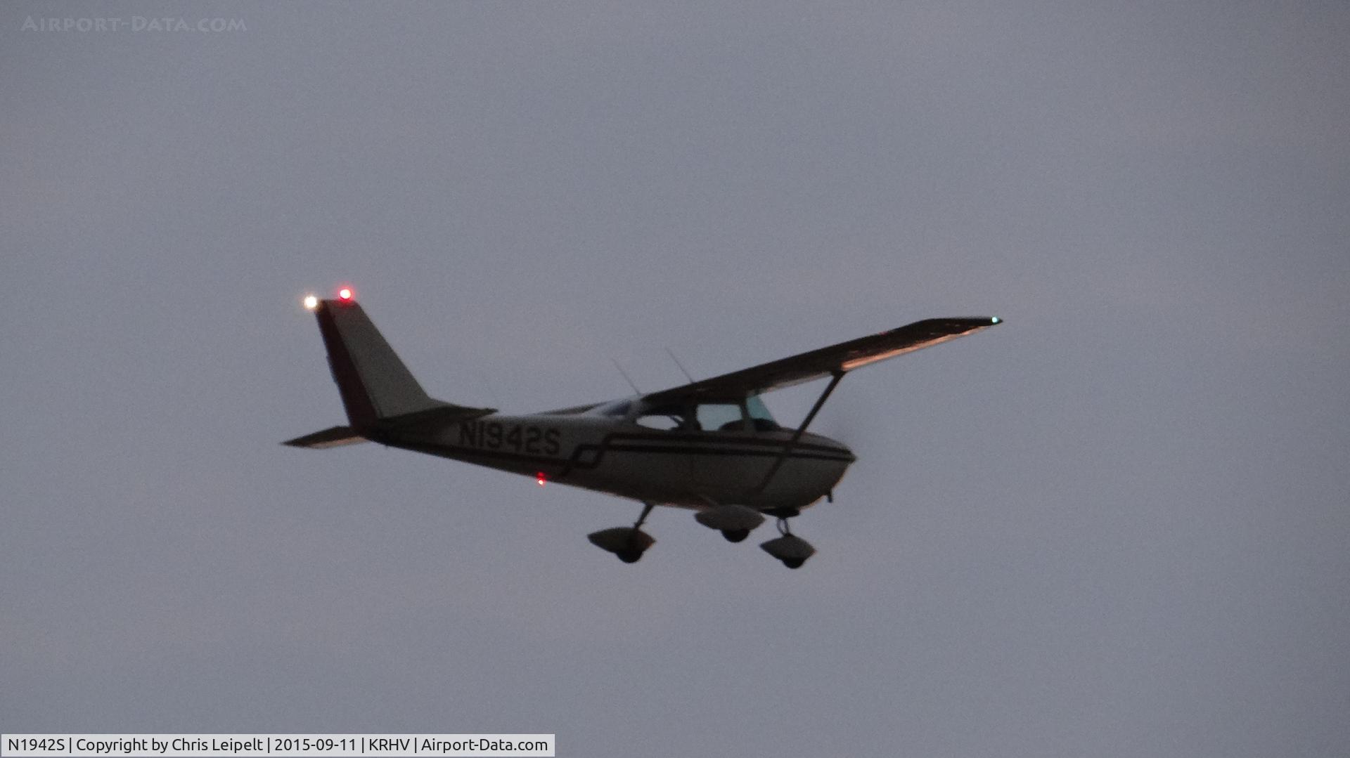 N1942S, 1964 Cessna 172E C/N 17251562, Very grainy picture of a locally-based 1964 Cessna 172E taking off as the sun goes down at Reid Hillview Airport, San Jose, CA. It was a really, really loud Cessna and this was the first time I've ever seen it fly. Might've been the last time at KRHV….