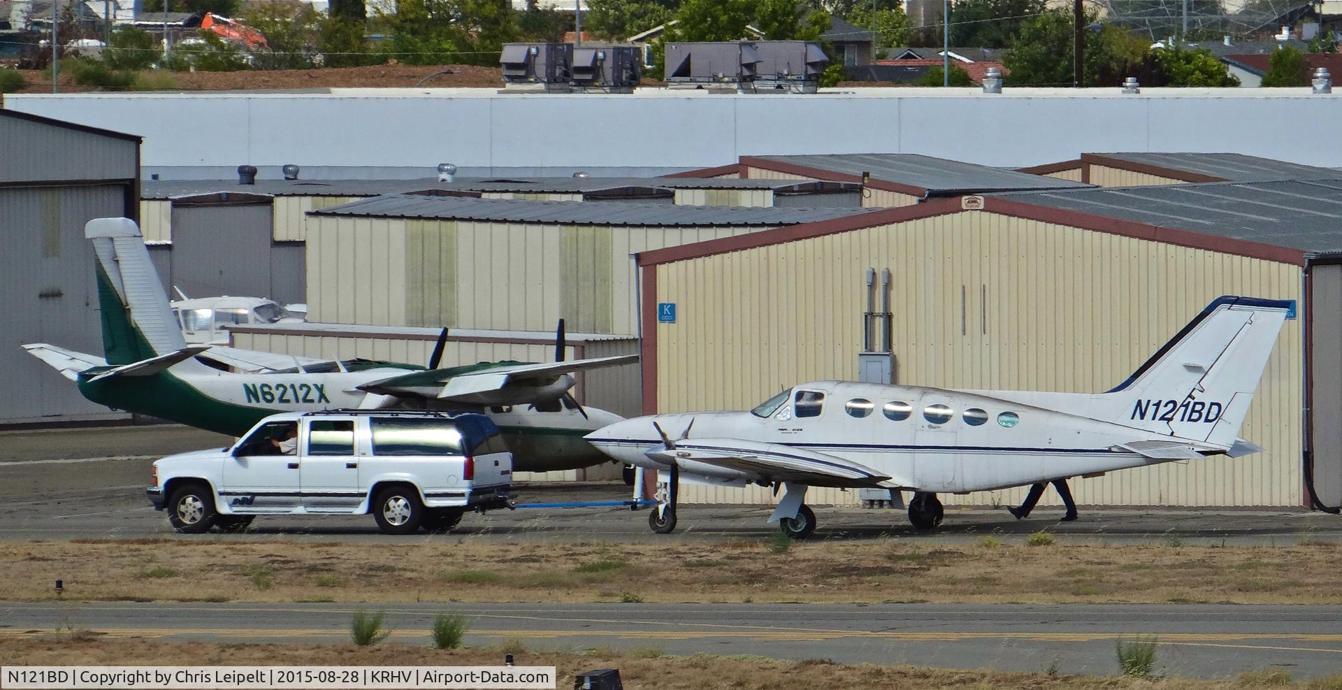 N121BD, 1979 Cessna 414A Chancellor C/N 414A0297, Locally-based 1979 Cessna 414A being moved from its tie down spot for the first time since 2009. Not airworthiness, so they had to connect a tow-bar onto a suburban then re position it to TradeWinds for LOTS of maintenance. Photo taken from the ATC tower.