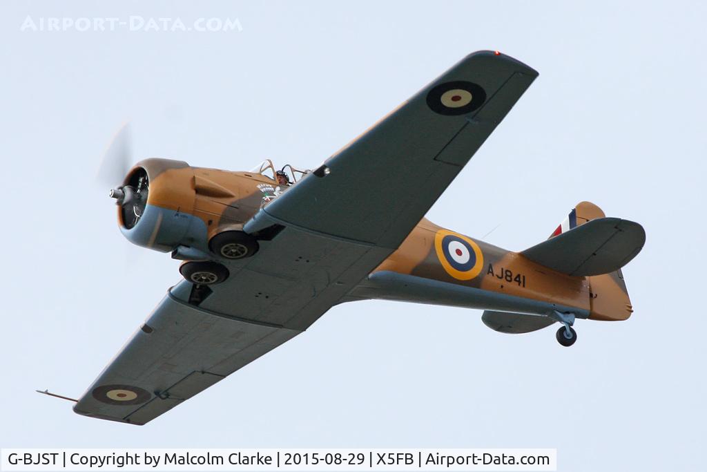 G-BJST, 1953 Canadian Car & Foundry T-6H Harvard Mk.4M C/N 14A-2429, Canadian Car & Foundry T-6H Harvard Mk4M, after an impromptu aerobatic display, leaves for Duxford in her new camouflage paint scheme. Fishburn Airfield, August 29th 2015.