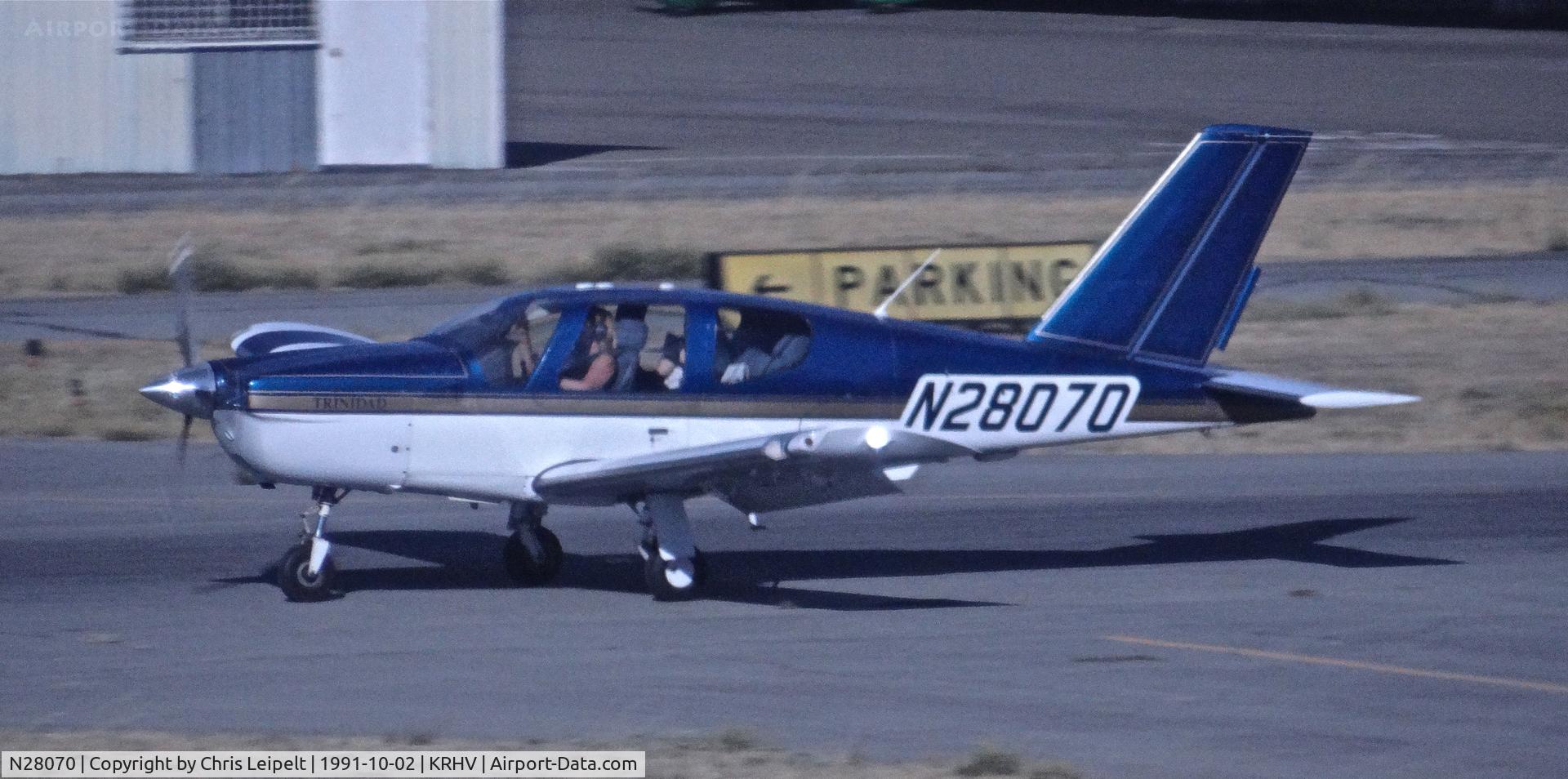 N28070, Socata TB-20 Trinidad C/N 1082, Transient Socata TB-20 Trinidad landing sometime in the early 1990's at Reid Hillview Airport, San Jose, CA. Photo taken from the control tower.