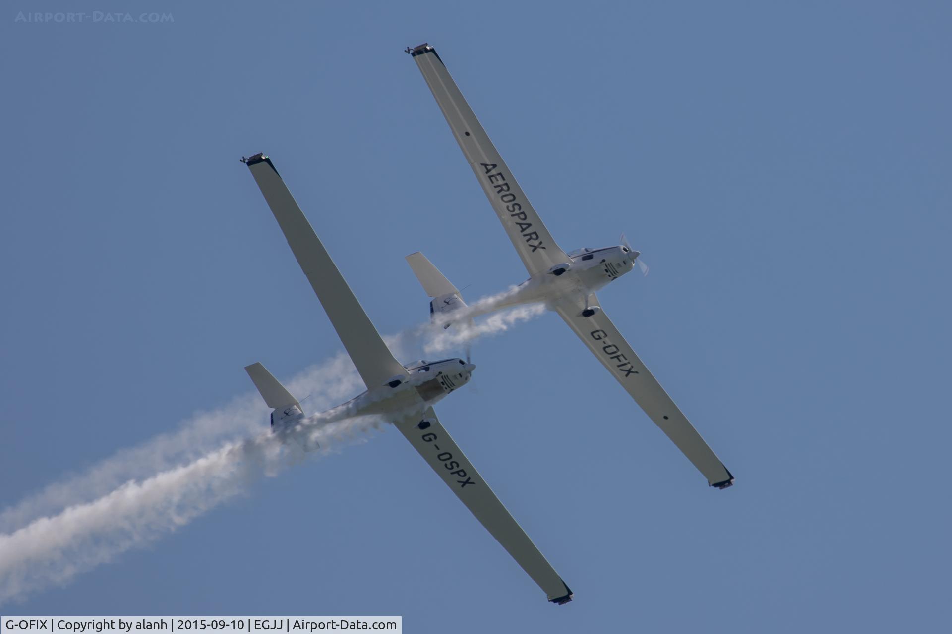 G-OFIX, 1985 Grob G-109B C/N 6394, Displaying over St Aubins Bay with G-OSPX as the Aerosparx at Jersey International Air Display 2015.